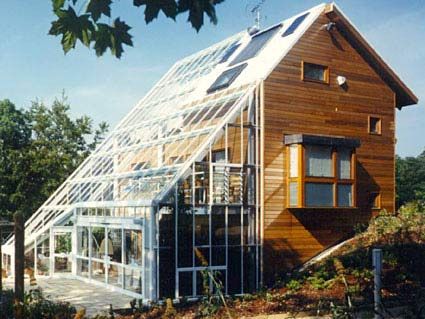 Why not go all the way and live in a greenhouse. This symbiotic relationship saves Energy and GHG Emissions all while your family watches the veggies grow. Thermal mass, shading, ventilation and moveable insulation are key factors.